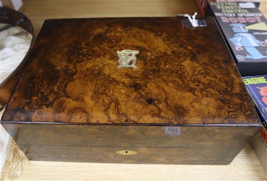 A burr walnut jewellery-cum-writing box, retailed by Thomas, 153 New Bond Street, London, W 39cm